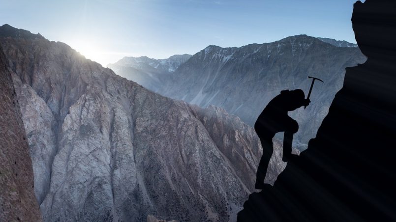 man climbing mountain